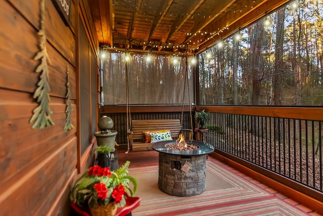 wooden terrace with a fire pit