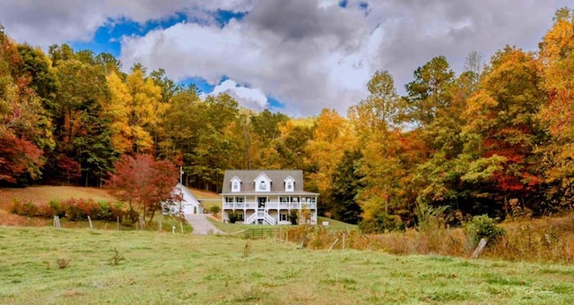 back of property featuring a lawn