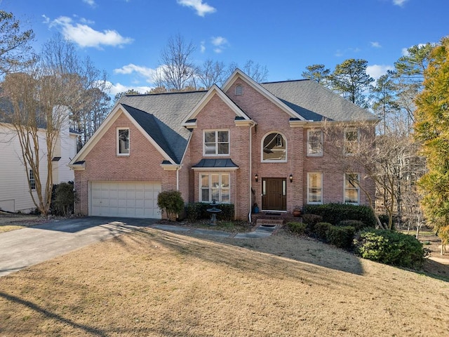 view of front facade with a garage, concrete driveway, and brick siding