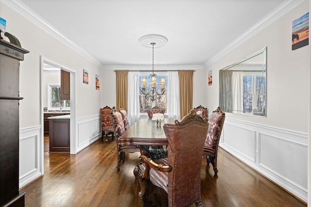 dining space featuring a healthy amount of sunlight, a chandelier, dark wood finished floors, and ornamental molding