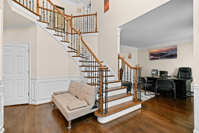 staircase with ornamental molding and wood finished floors