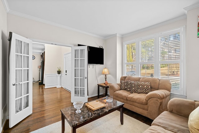 living room with ornamental molding, wood finished floors, and french doors