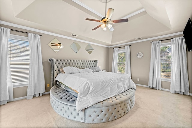 bedroom featuring a raised ceiling, visible vents, and multiple windows