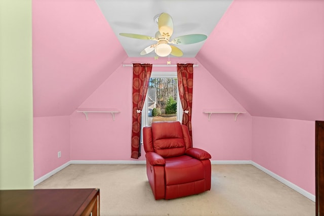 living area featuring a ceiling fan, carpet, lofted ceiling, and baseboards