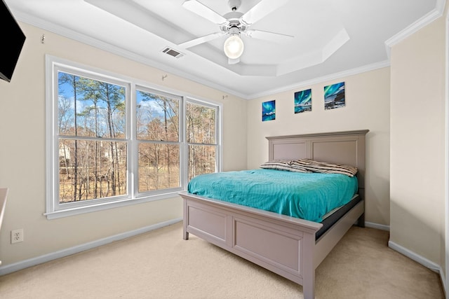 bedroom featuring crown molding, a raised ceiling, light colored carpet, visible vents, and baseboards