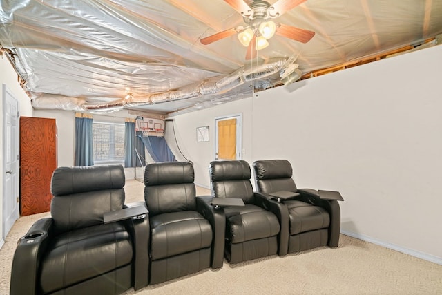 carpeted home theater room with a ceiling fan and baseboards