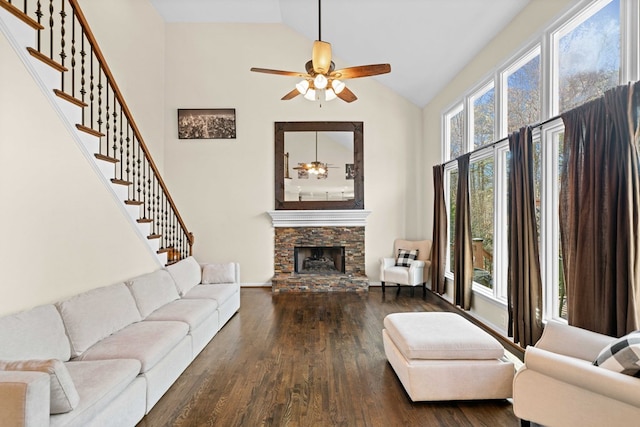 living room featuring high vaulted ceiling, a fireplace, wood finished floors, a ceiling fan, and stairs