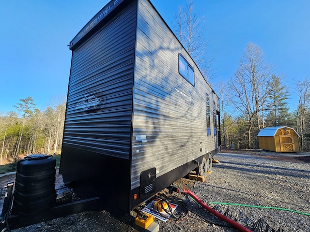 view of home's exterior featuring a storage unit