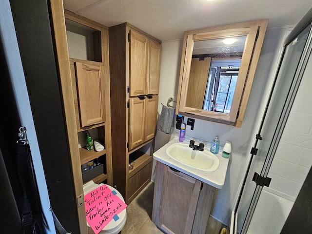 bathroom with vanity and a shower with shower door