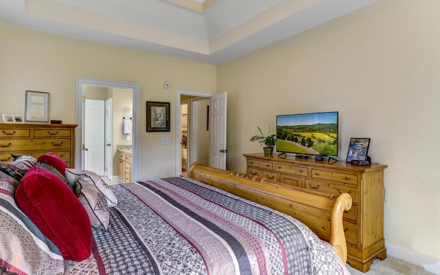 bedroom featuring light carpet and ensuite bathroom