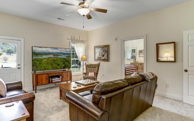 living room with a healthy amount of sunlight, light colored carpet, and ceiling fan