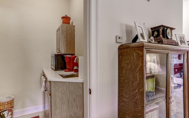 room details featuring sink and tile patterned flooring