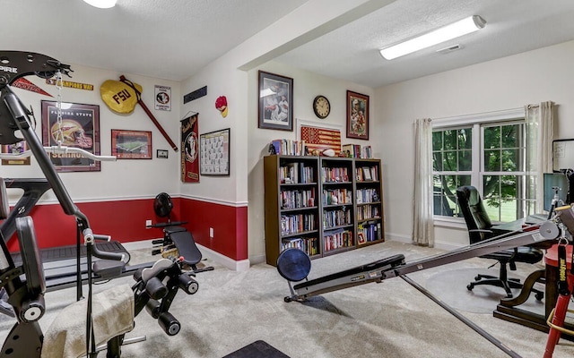 workout room with carpet floors and a textured ceiling