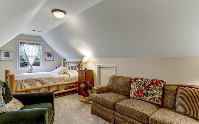 bedroom with vaulted ceiling and light colored carpet