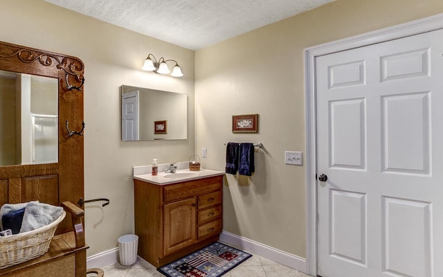 bathroom featuring vanity, tile patterned floors, and a textured ceiling