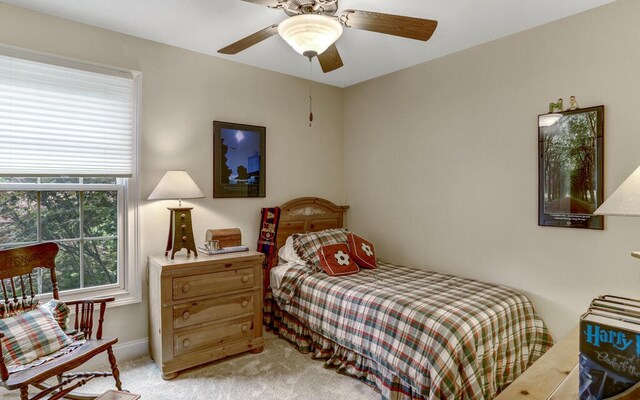 bedroom featuring light carpet and ceiling fan