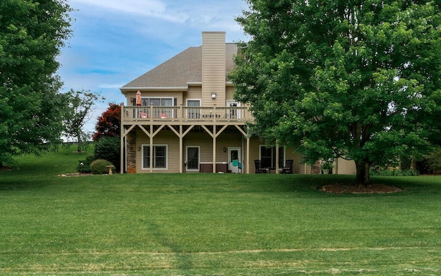 rear view of house featuring a yard and a wooden deck