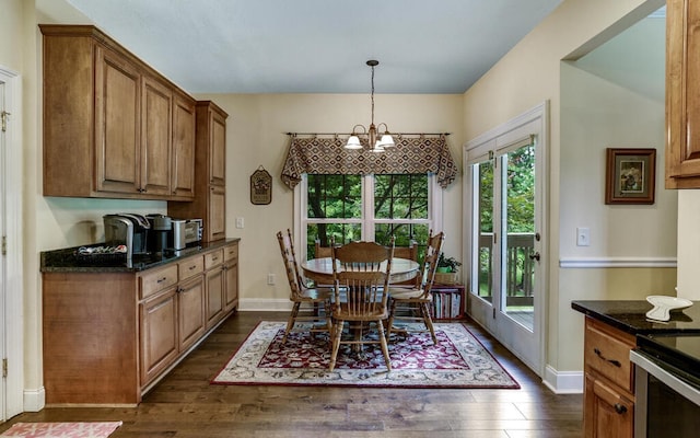 dining space featuring a notable chandelier and dark hardwood / wood-style flooring