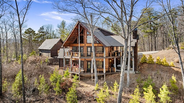 back of house with a wooden deck