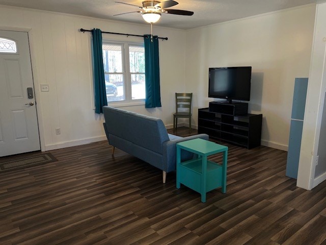 living room with ceiling fan, dark hardwood / wood-style floors, and ornamental molding