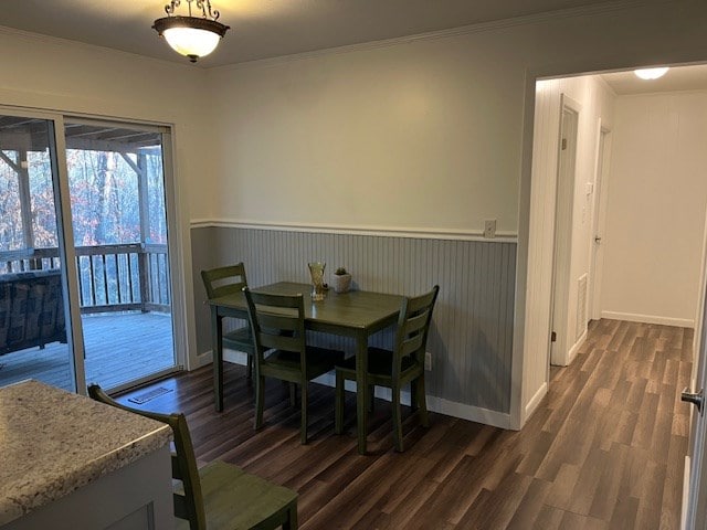 dining area featuring crown molding and dark hardwood / wood-style floors