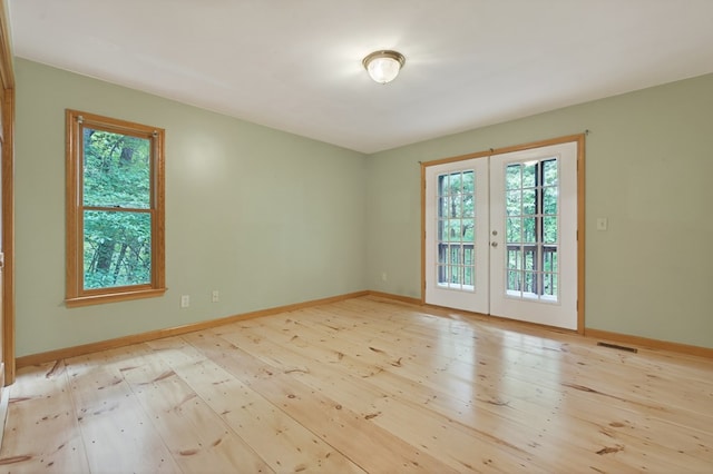 776 Mountain Oak Rd, Ellijay, GA 30536 - empty room with french doors, healthy amount of natural light, and hardwood / wood-style floors