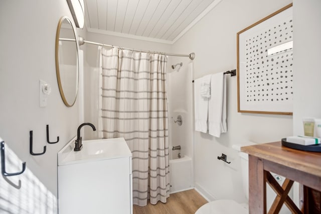 full bathroom featuring crown molding, shower / bathtub combination with curtain, toilet, vanity, and wood finished floors