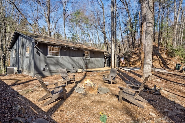 exterior space featuring a fire pit and central AC