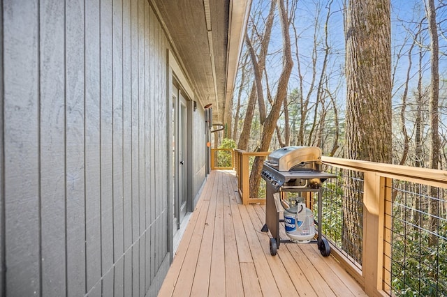 wooden deck featuring a grill