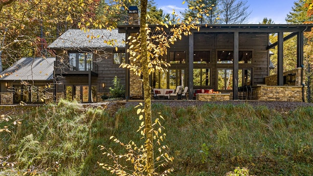 back of property with a balcony