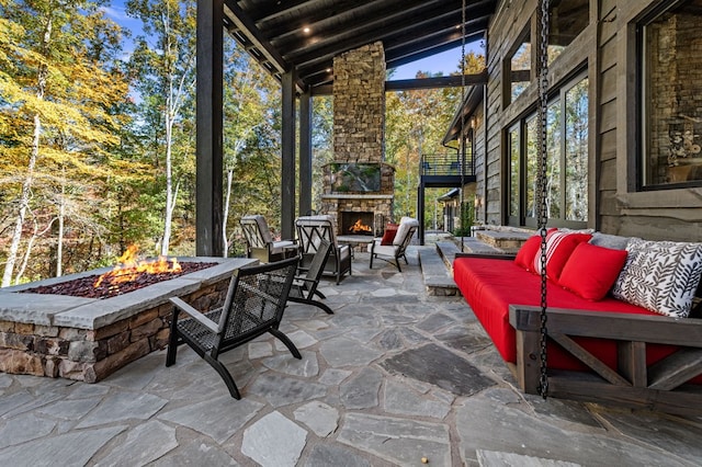 view of patio with an outdoor living space with a fireplace