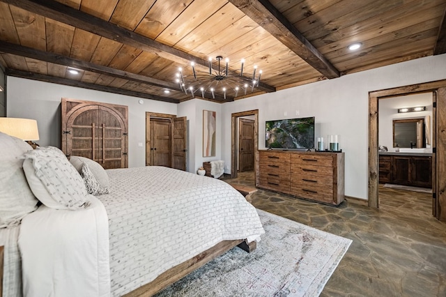 bedroom featuring beam ceiling, ensuite bathroom, wood ceiling, and an inviting chandelier