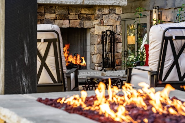 exterior details featuring a fireplace and an outdoor fire pit