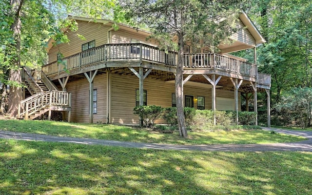 view of front of property with a deck and a front lawn