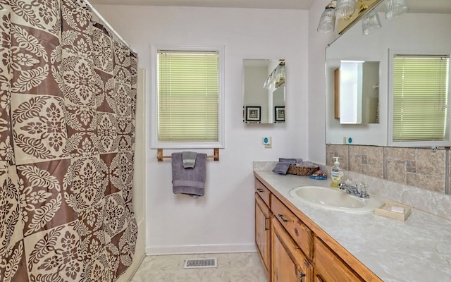 bathroom featuring curtained shower and vanity