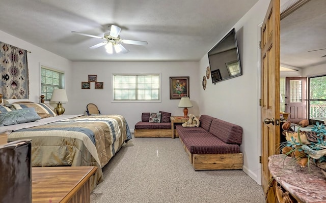 carpeted bedroom featuring a textured ceiling and ceiling fan