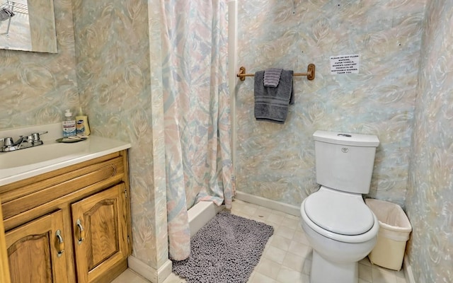 bathroom featuring vanity, toilet, and curtained shower