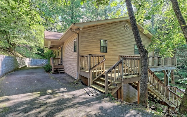 view of side of property featuring a wooden deck