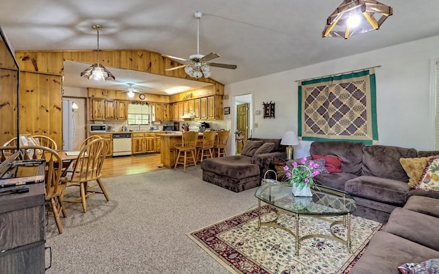 living room featuring ceiling fan, lofted ceiling, and light carpet