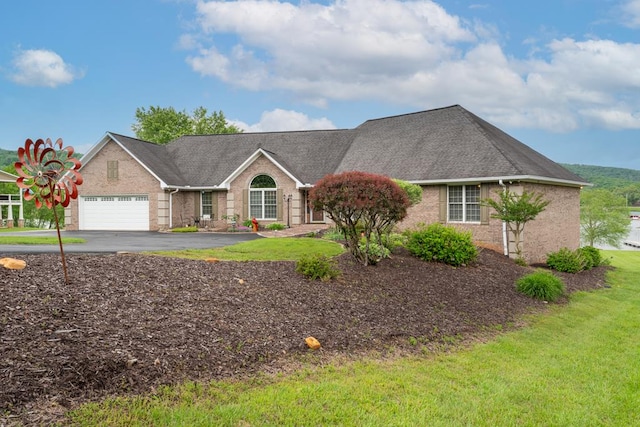 1537 Victoria Woods Dr, Hiawassee, GA 30546 - view of front facade featuring a garage, driveway, brick siding, a front lawn, and roof with shingles