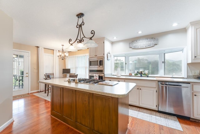 1537 Victoria Woods Dr, Hiawassee, GA 30546 - kitchen featuring appliances with stainless steel finishes, a sink, light countertops, a chandelier, and recessed lighting