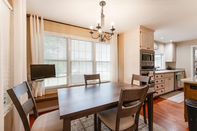 1537 Victoria Woods Dr, Hiawassee, GA 30546 - dining space featuring a chandelier and light wood-style floors