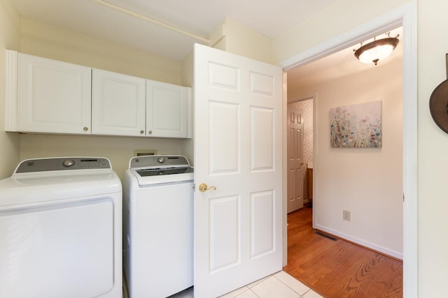 1537 Victoria Woods Dr, Hiawassee, GA 30546 - laundry area featuring cabinet space, washing machine and dryer, light tile patterned floors, and baseboards