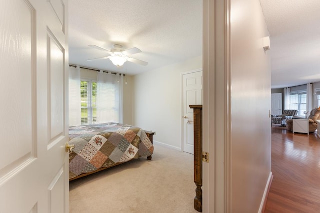 1537 Victoria Woods Dr, Hiawassee, GA 30546 - bedroom with baseboards, a ceiling fan, a textured ceiling, and wood finished floors