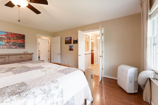 1537 Victoria Woods Dr, Hiawassee, GA 30546 - bedroom featuring light wood-type flooring, a ceiling fan, and baseboards