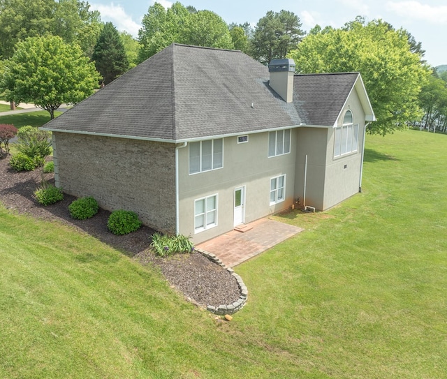 1537 Victoria Woods Dr, Hiawassee, GA 30546 - back of property with roof with shingles, a chimney, a patio, a lawn, and stucco siding
