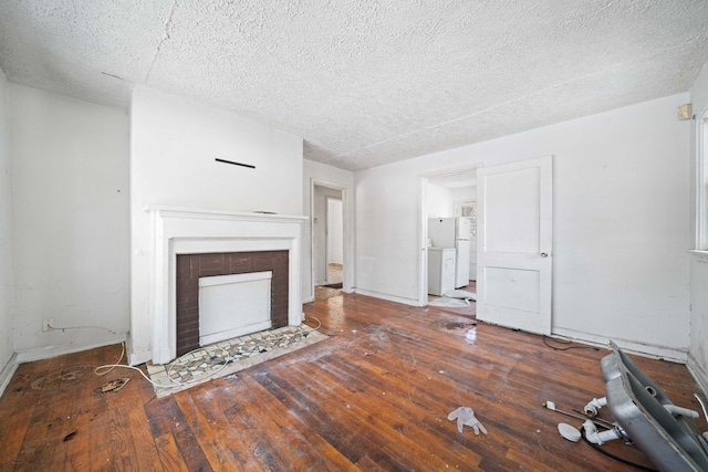 unfurnished living room featuring dark hardwood / wood-style floors and a textured ceiling