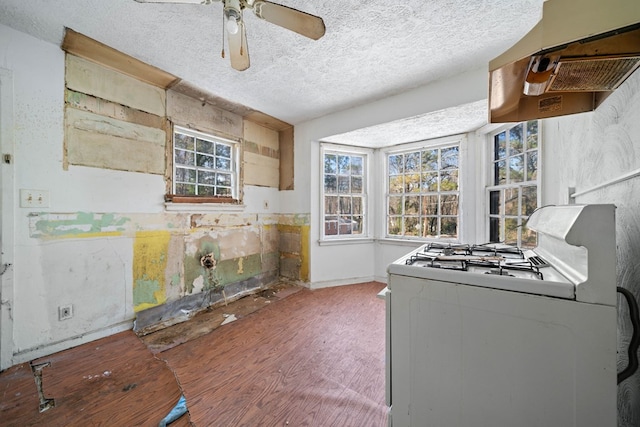 kitchen featuring ceiling fan, white gas range oven, and a textured ceiling