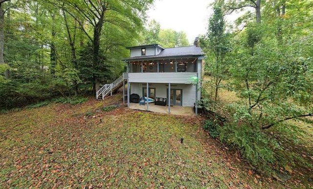 back of house featuring a patio and a sunroom