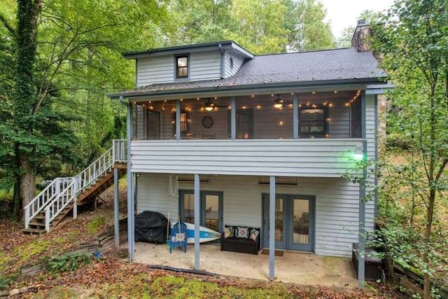 rear view of house with a sunroom and a patio area